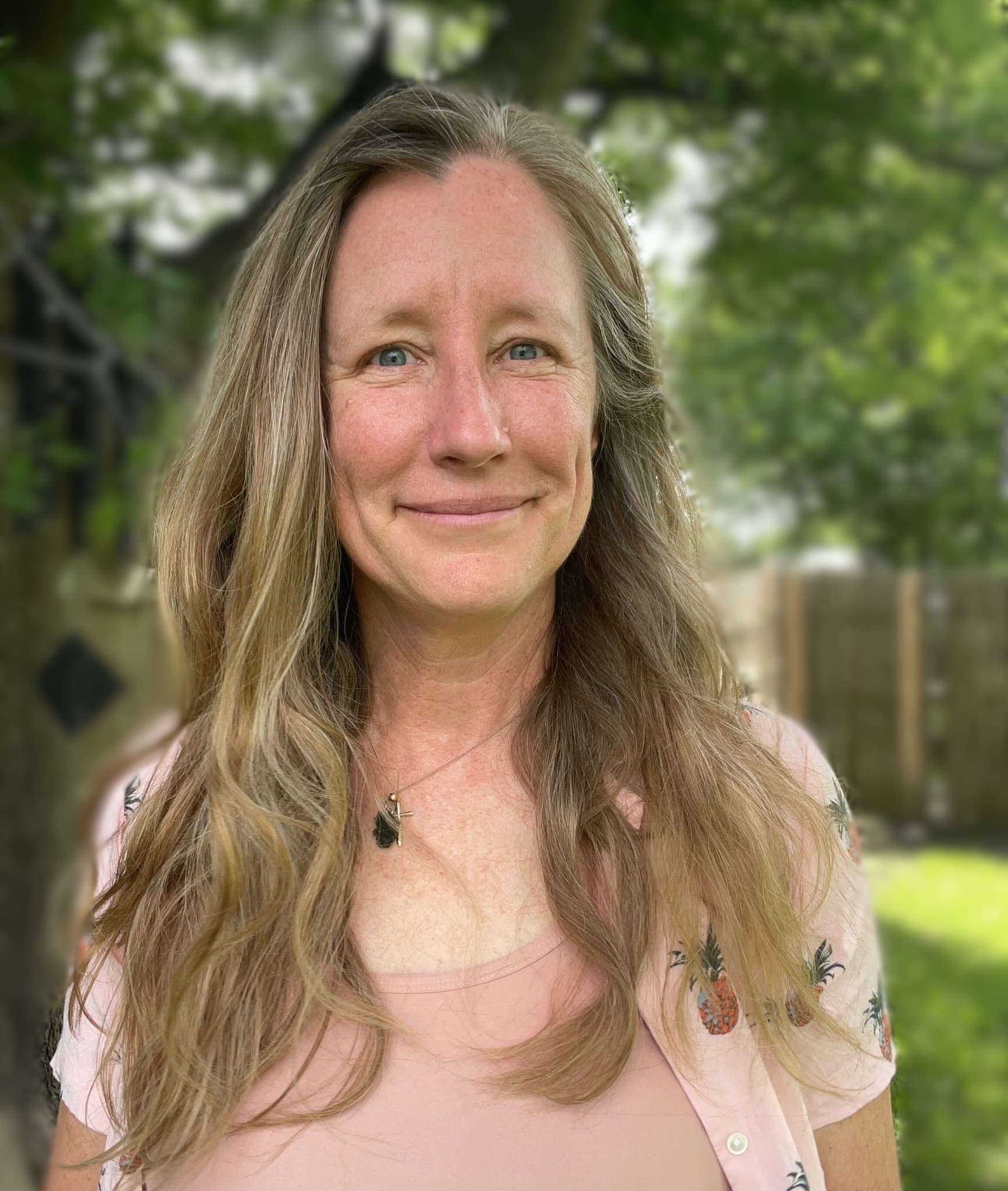Heather outdoors in a pink top